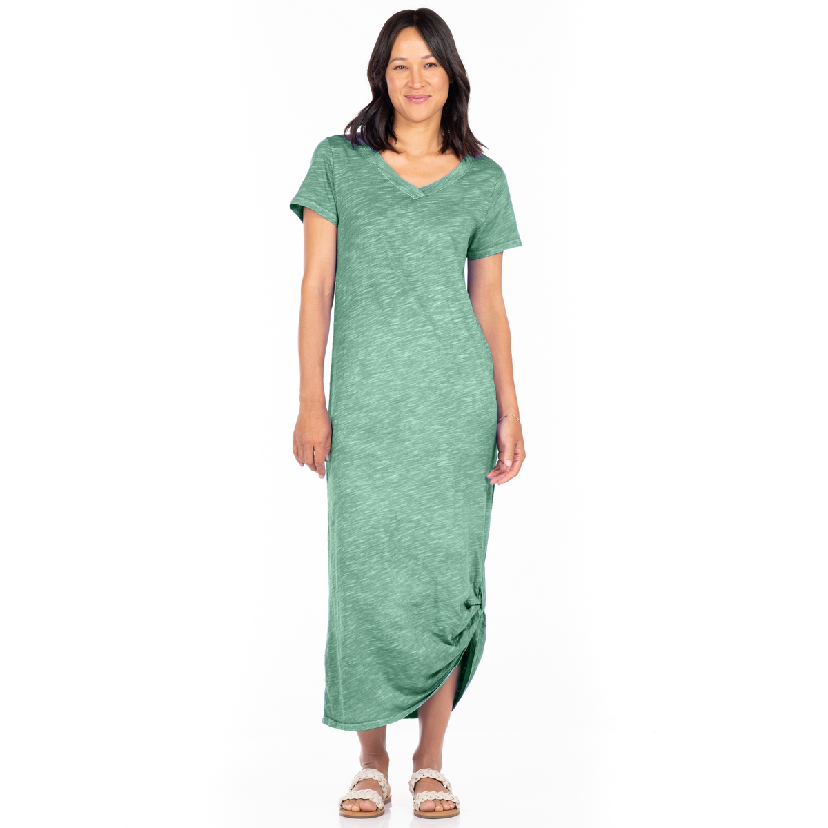 A woman wears the Fresh Produce Clothes Christa Dress Clearance, a seafoam green, short-sleeved, V-neck midi dress with a knot detail at the hem.